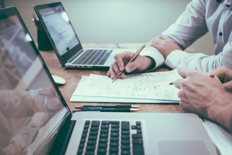 Printed charts and a calculator on a desk during a budget review